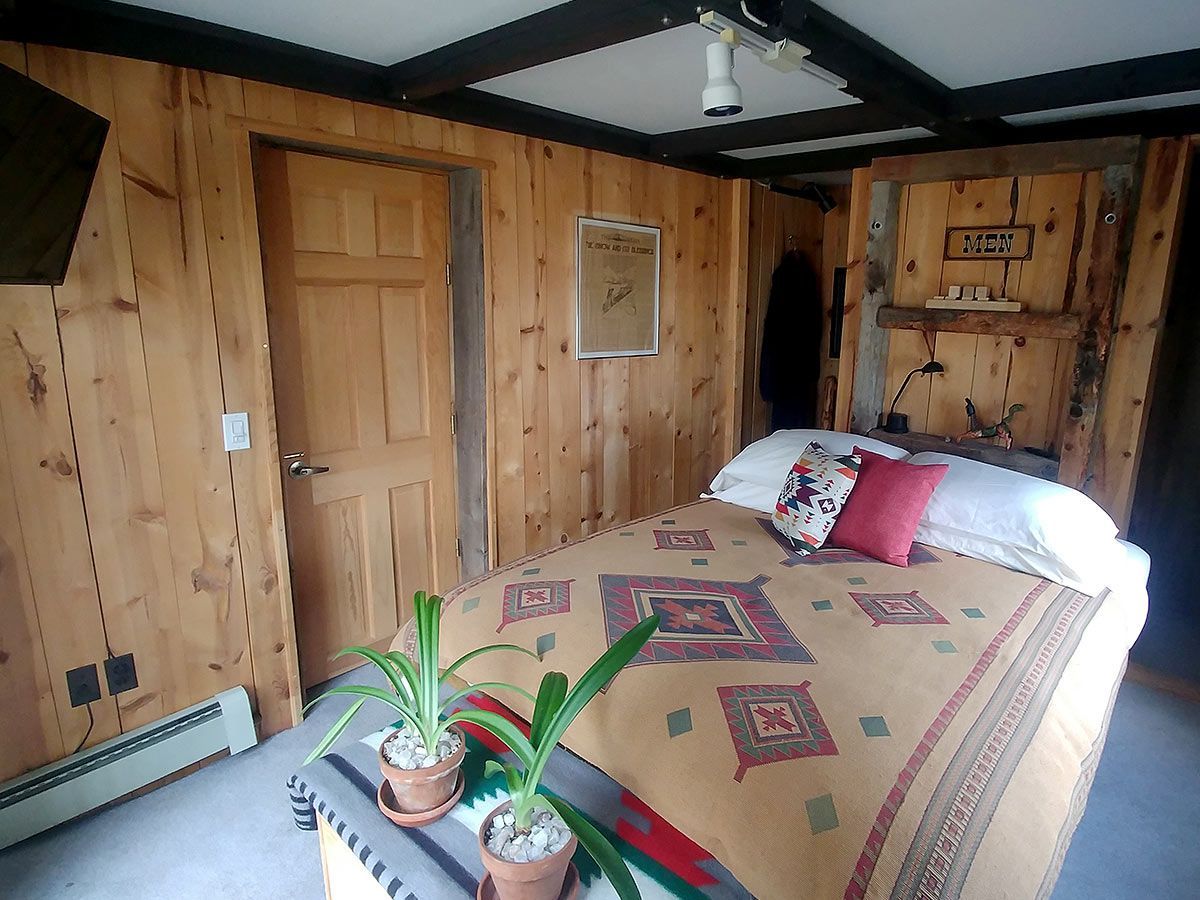 A bedroom with two bunk beds and a rug.