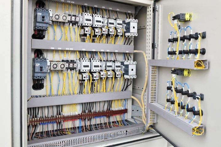 Electrical control panel with wires and components.