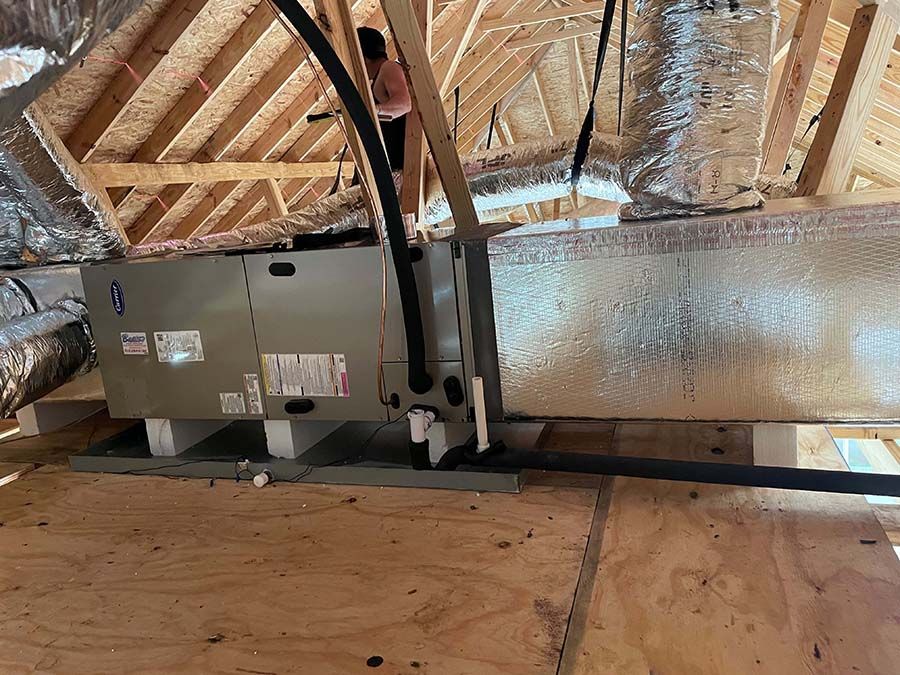 An air conditioner is hanging from the ceiling of a building.