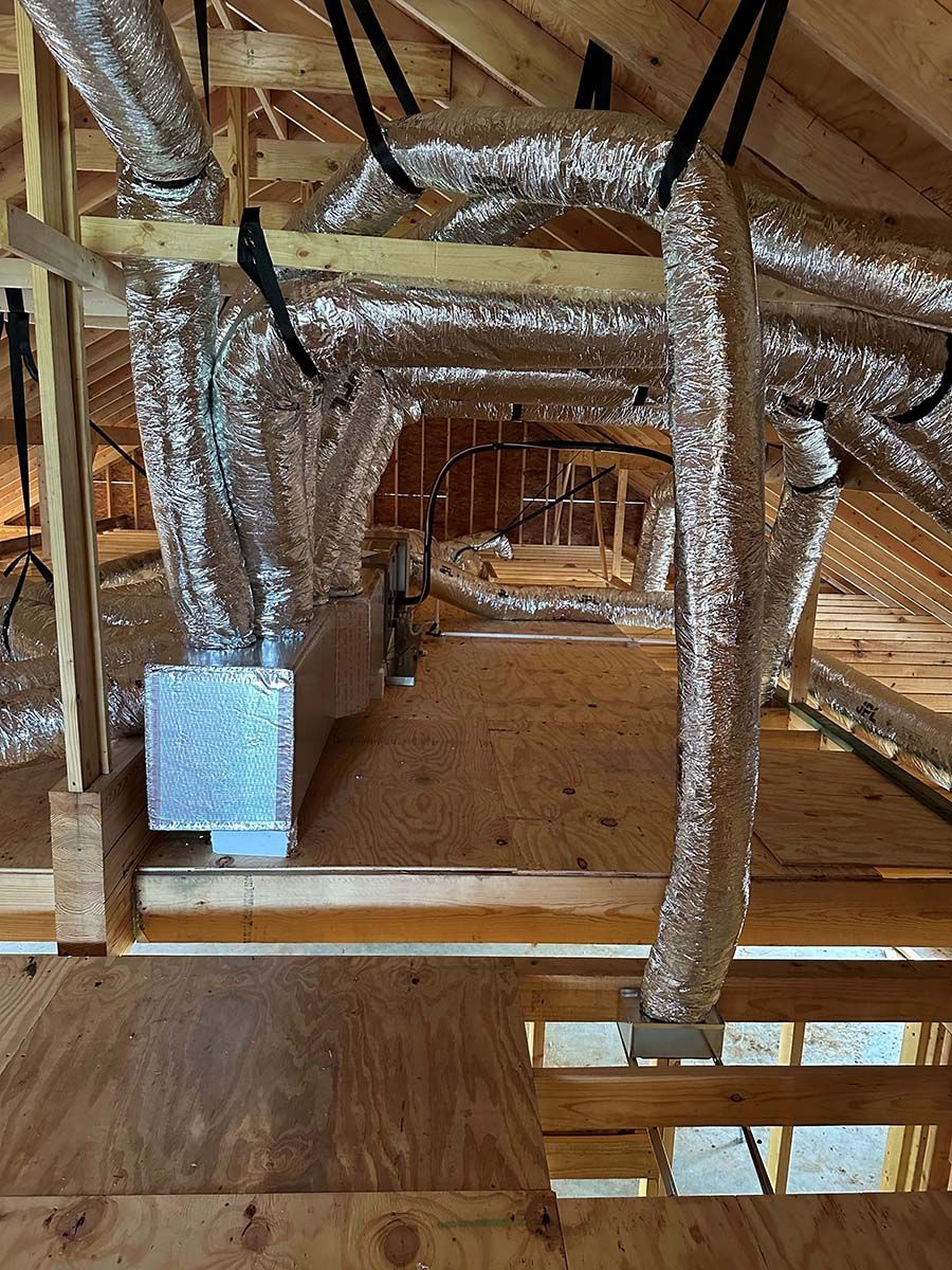 A room with a lot of pipes hanging from the ceiling.