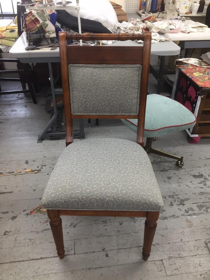 A chair is sitting in a room next to a table.