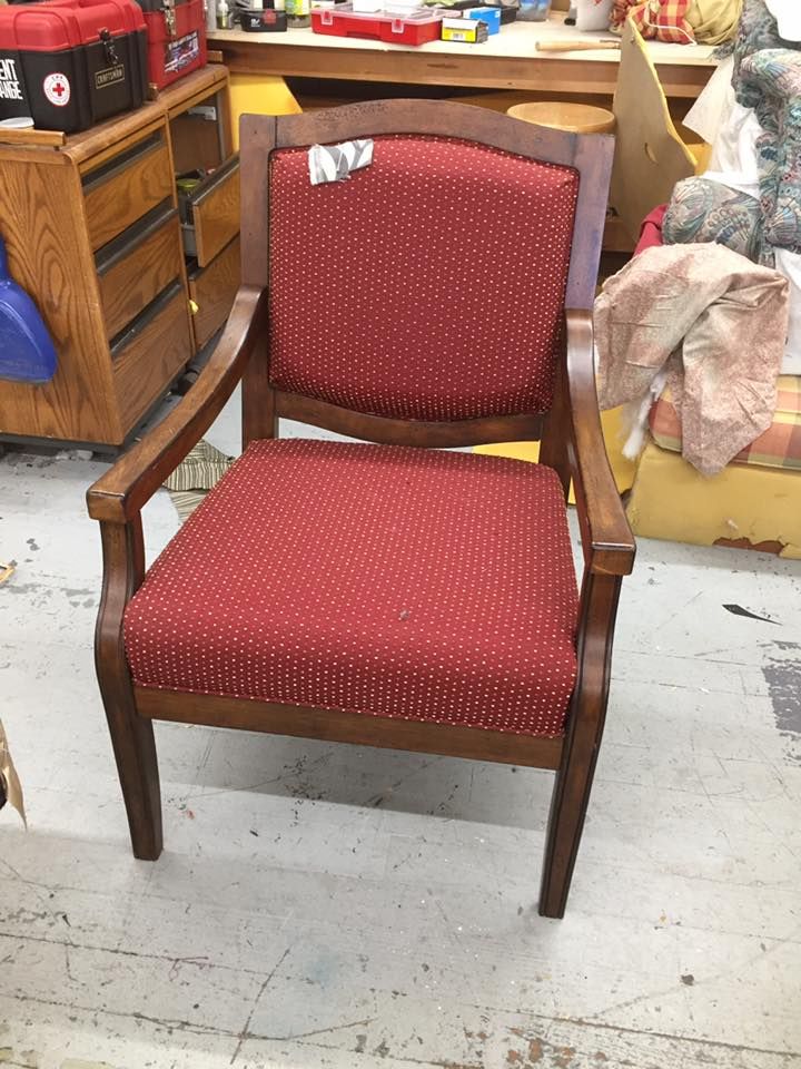 A wooden chair with a red polka dot seat and back