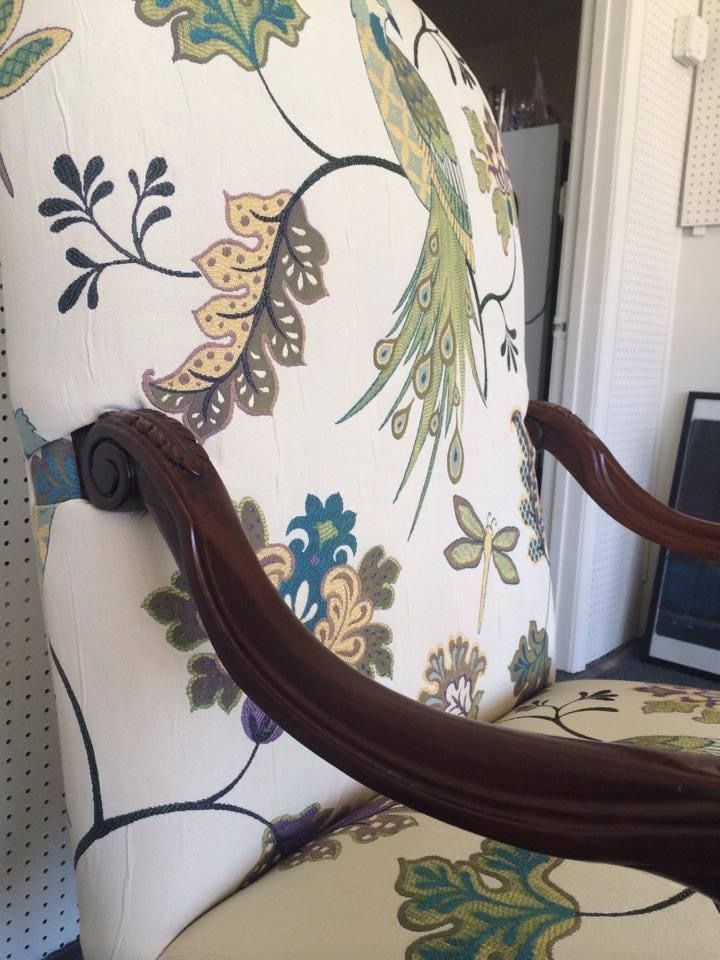 A chair with a peacock pattern on it