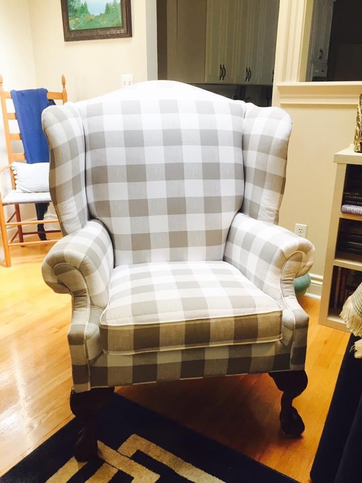 A grey and white checkered chair in a living room