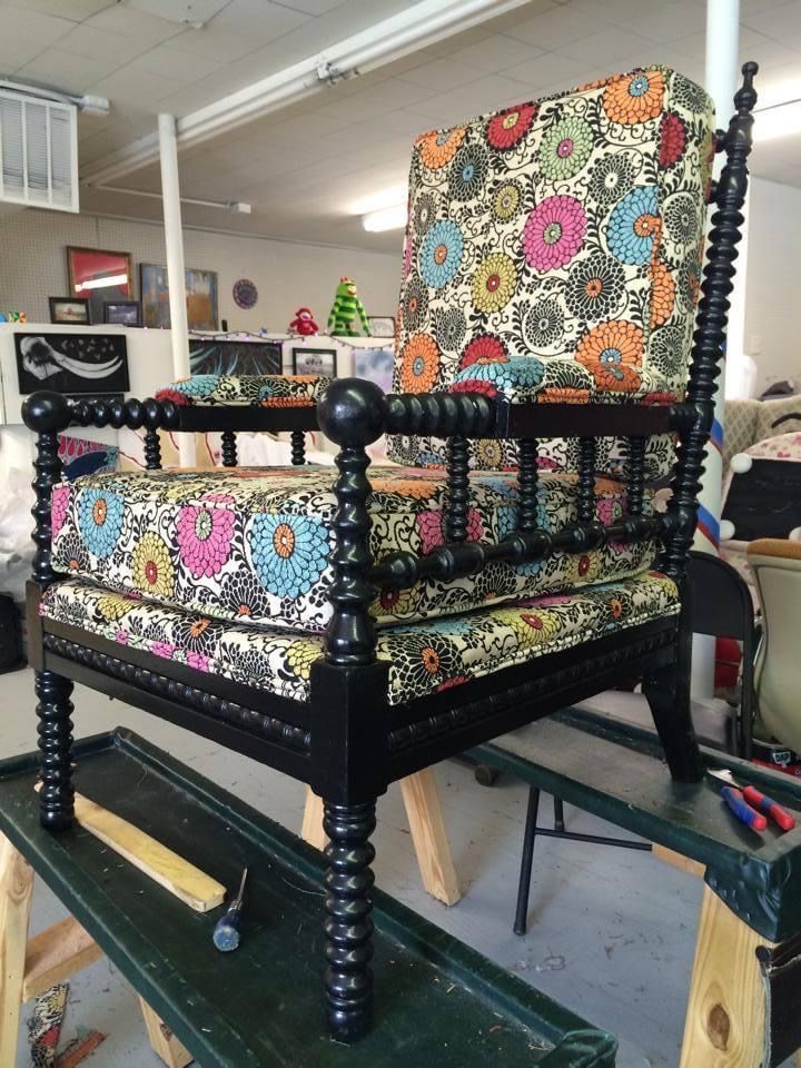 A chair with a floral cushion is sitting on a table