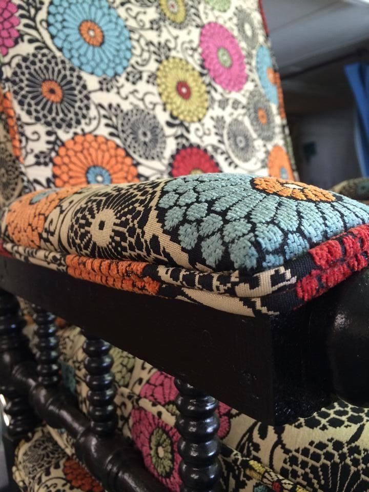 A chair with a colorful floral pattern on it