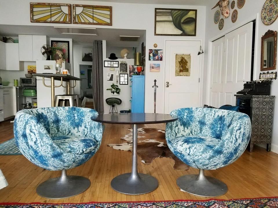 A living room with two chairs and a table