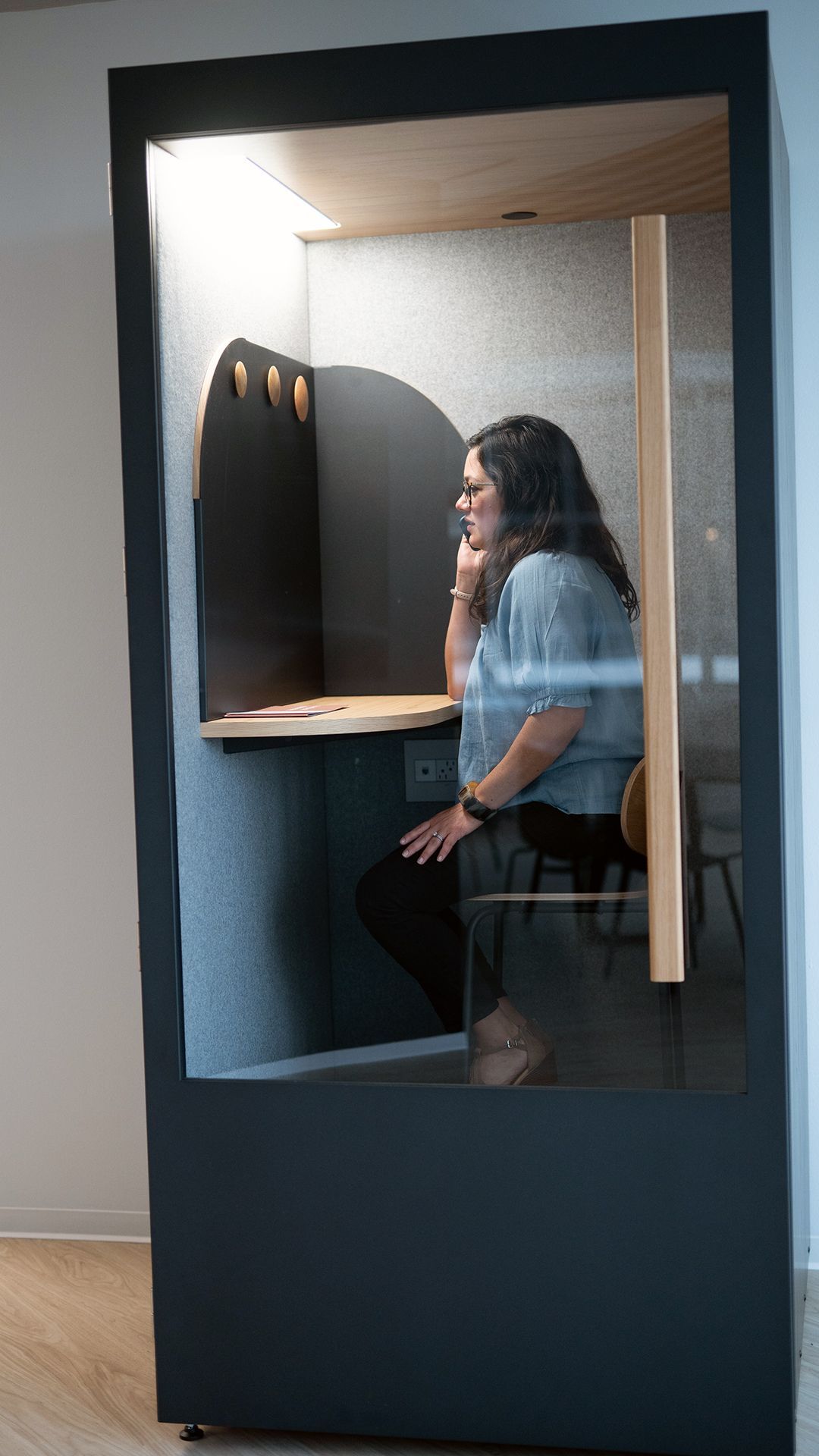 woman in a private phone booth