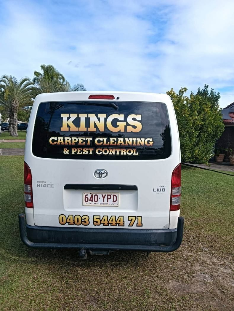 The Back of a White Van is Parked in a Grassy Field — King's John Carpet Kleaning & Pest Control In Currimundi, QLD