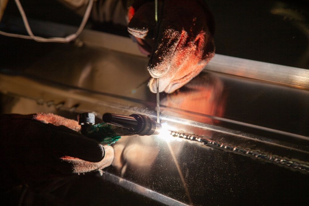 Man Using Tig Welding For The Aluminum Boat — Brumb's Welding & Fabrication in Biggera Waters, QLD