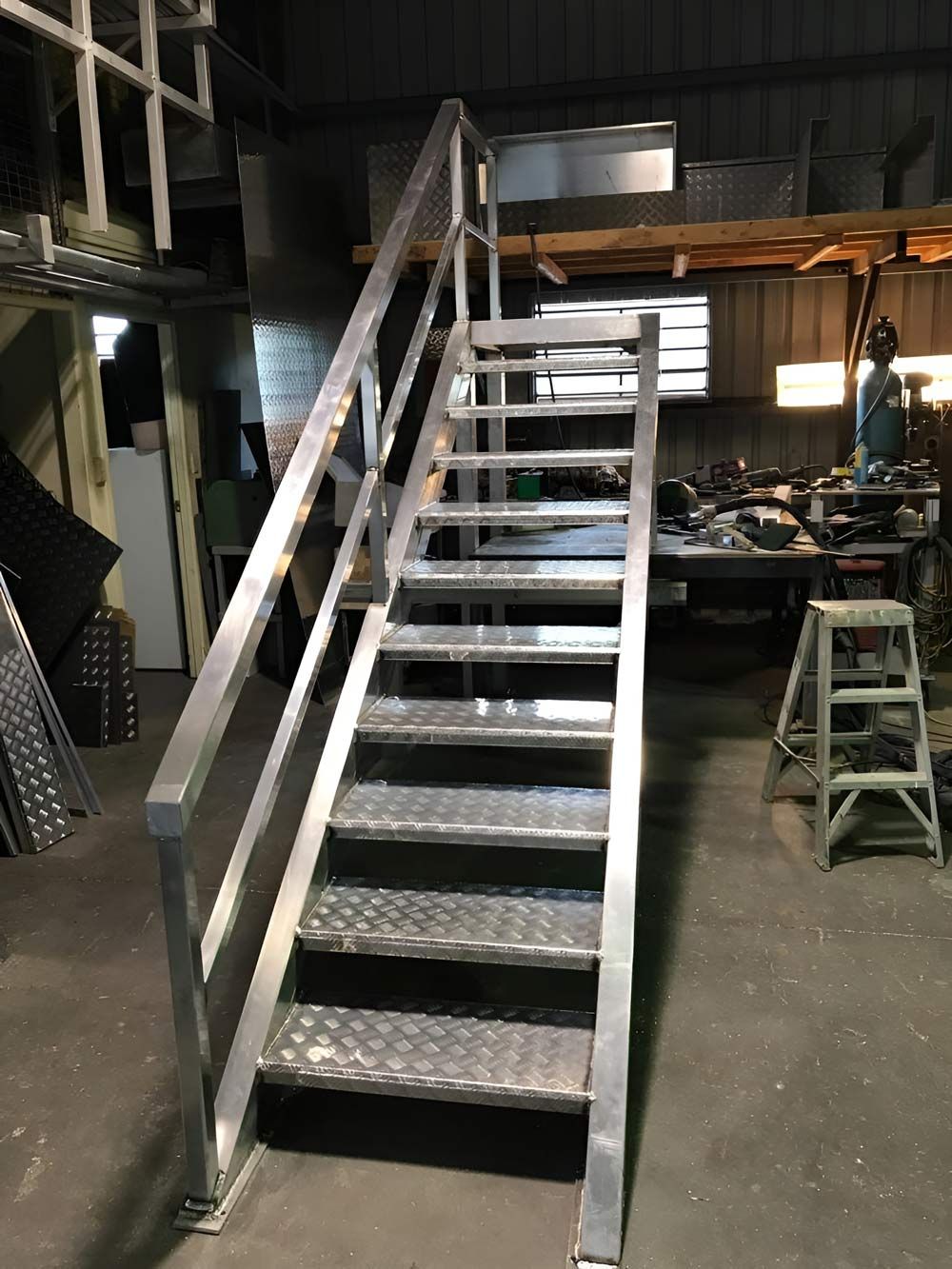 A Metal Staircase With A Railing In A Warehouse — Brumb's Welding & Fabrication in Biggera Waters, QLD