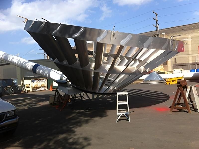 Large Metal Dish With Nearby Ladder