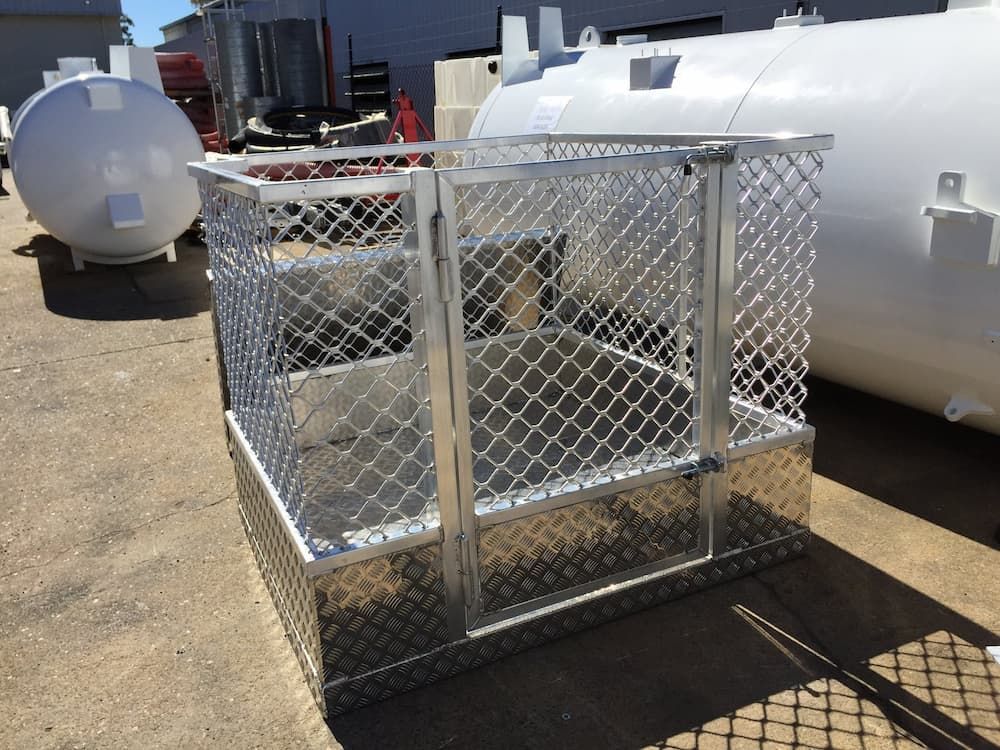 Metal Storage Cage With Chain-link Mesh and Checkered Base Sits Outdoors on Concrete