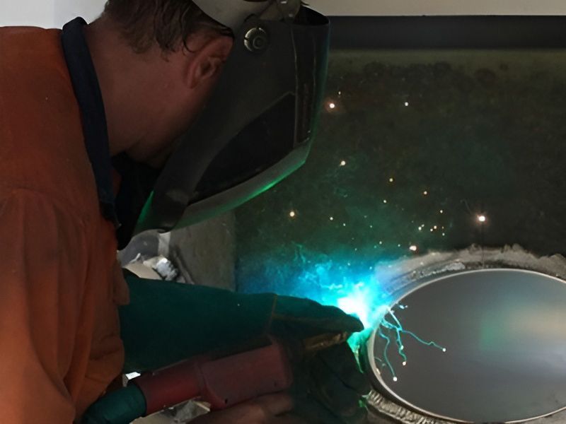 Man Is Welding The Piece Of Metal — Brumb's Welding & Fabrication in Biggera Waters, QLD