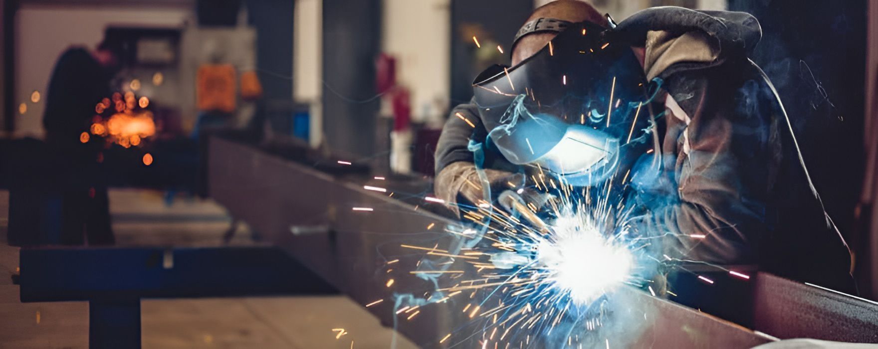 Experienced Welders With Torch And Helmet — Brumb's Welding & Fabrication in Biggera Waters, QLD