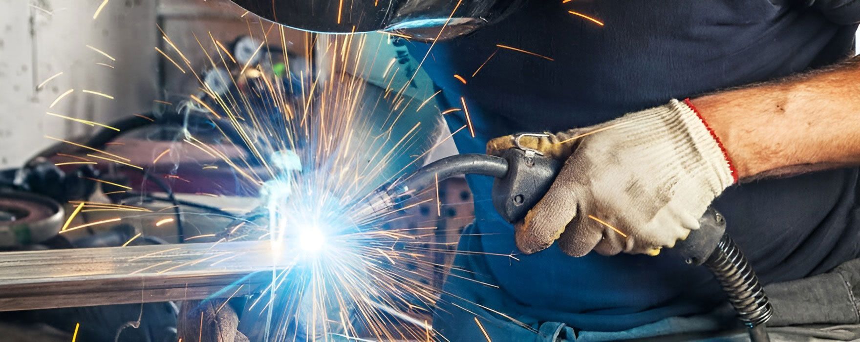 Man Uses A Welding Machine In A Workshop — Brumb's Welding & Fabrication in Biggera Waters, QLD