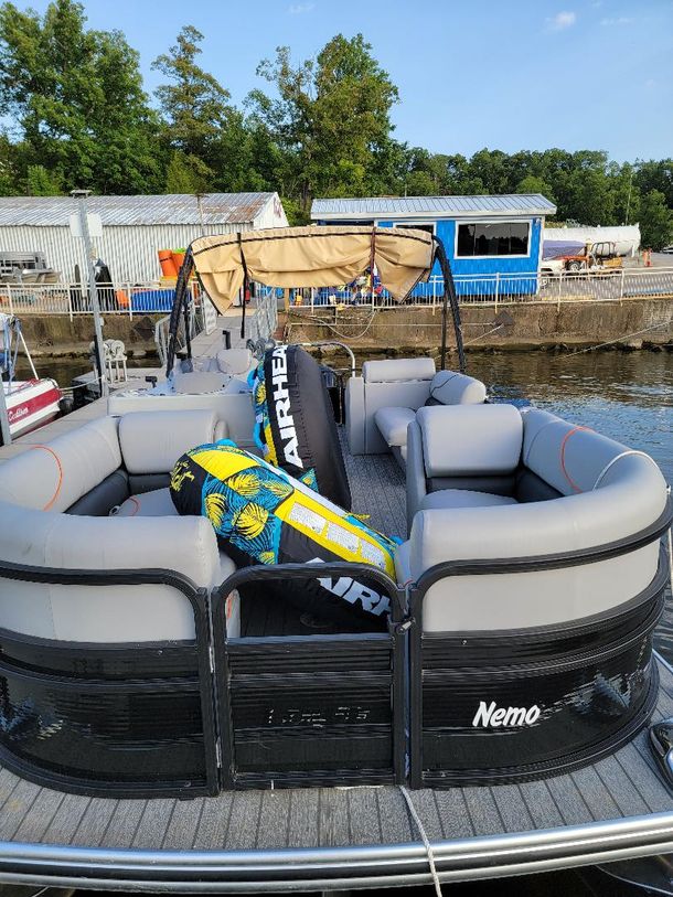 Dirty Duck Boat Rentals | Lake of the Ozarks a pontoon boat with a raft attached to it