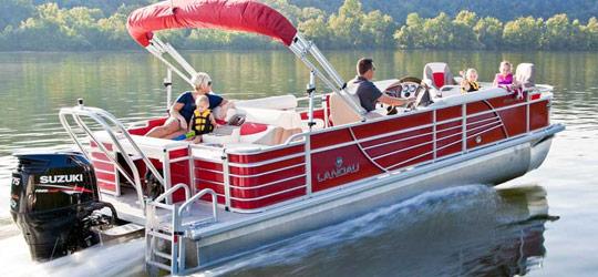 Dirty Duck Boat Rentals | Lake of the Ozarks a group of people are riding a pontoon boat on a lake .