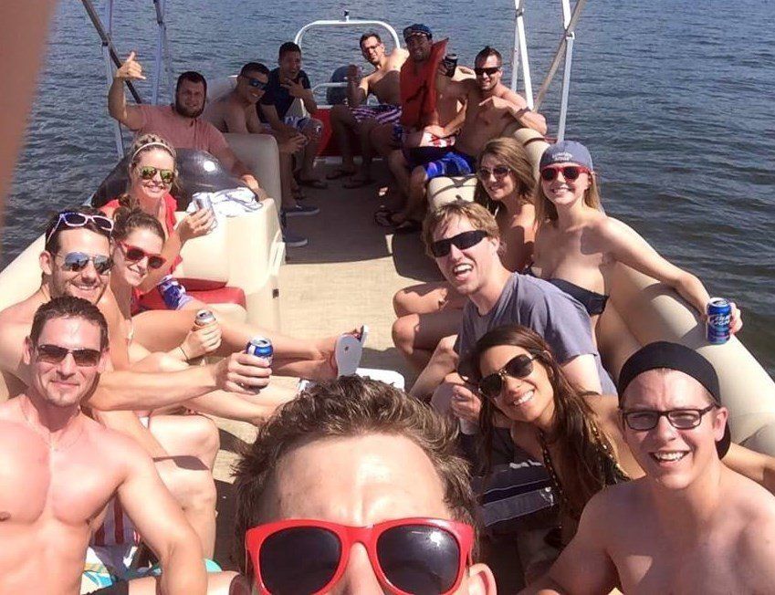 Dirty Duck Boat Rentals | Lake of the Ozarks a group of people are posing for a picture on a boat