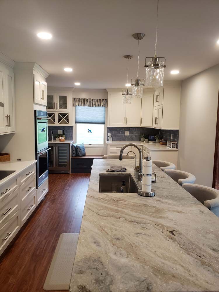 A kitchen with a large island and a sink.