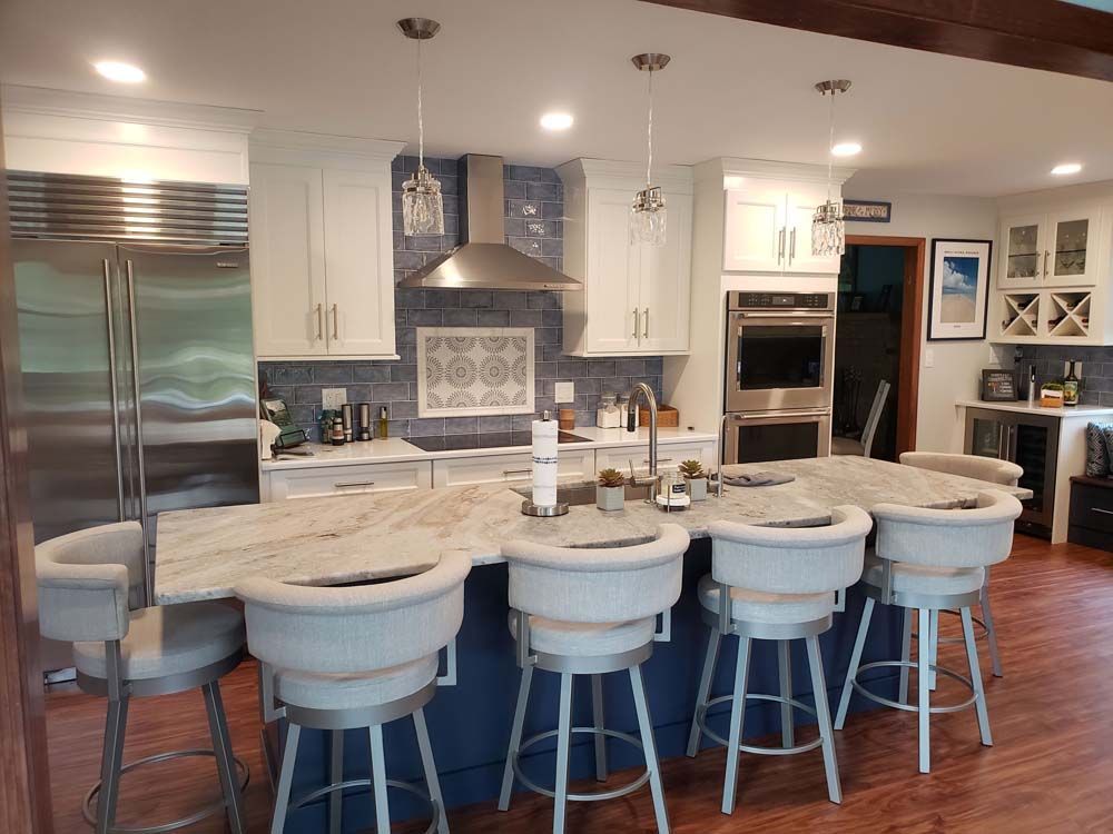 A kitchen with a large island and stools