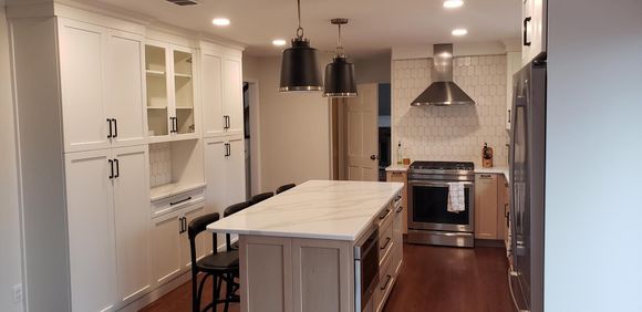 There is a large island in the middle of the kitchen.