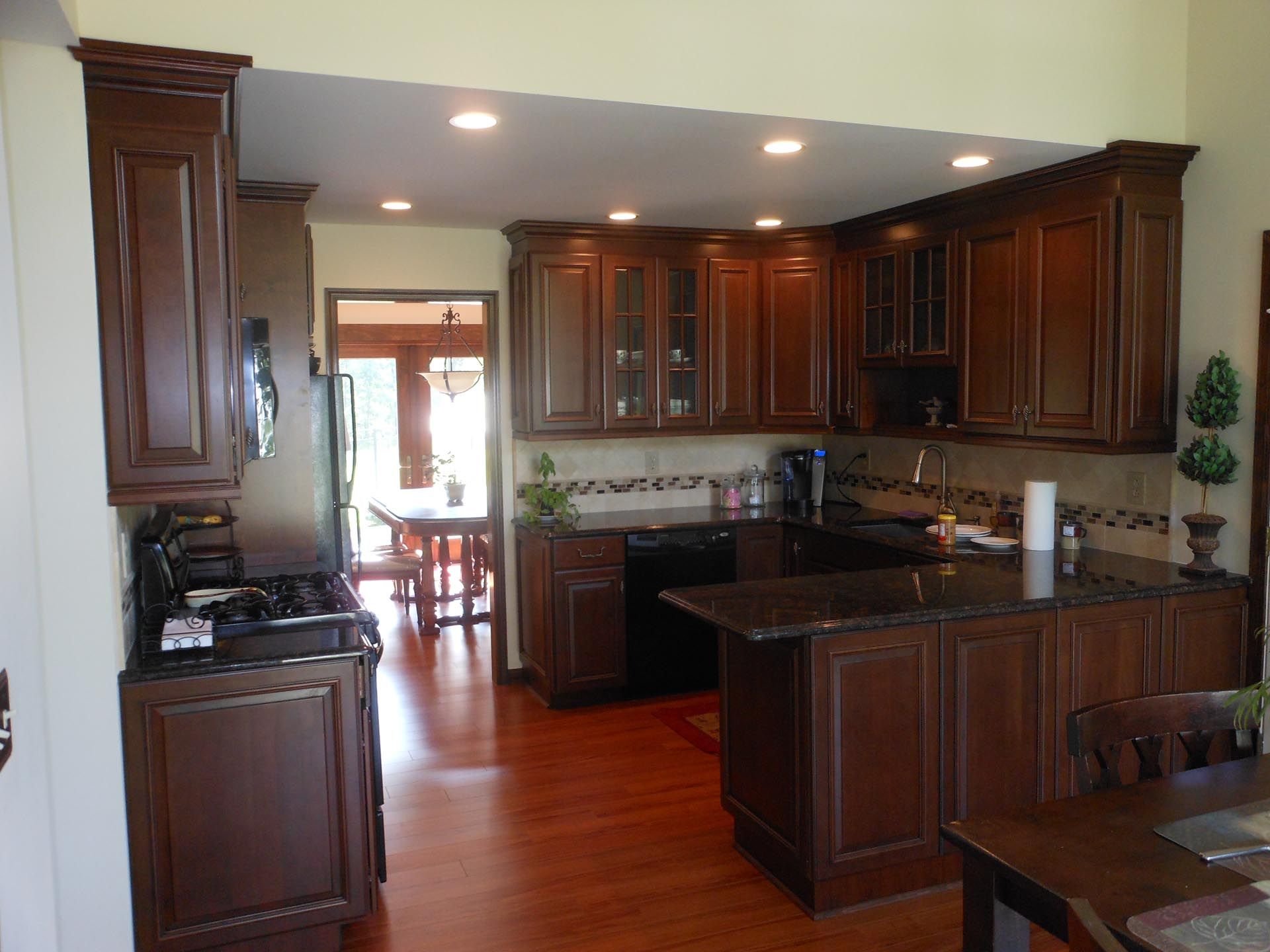 A kitchen with wooden cabinets and granite counter tops.