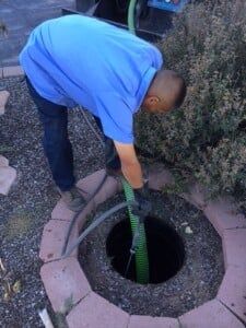 Man Cleaning The Sewer — Albuquerque, NM — AAA Pumping Service Inc.