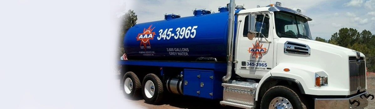 Worker Holding Pipe — Albuquerque, NM — AAA Pumping Service Inc.