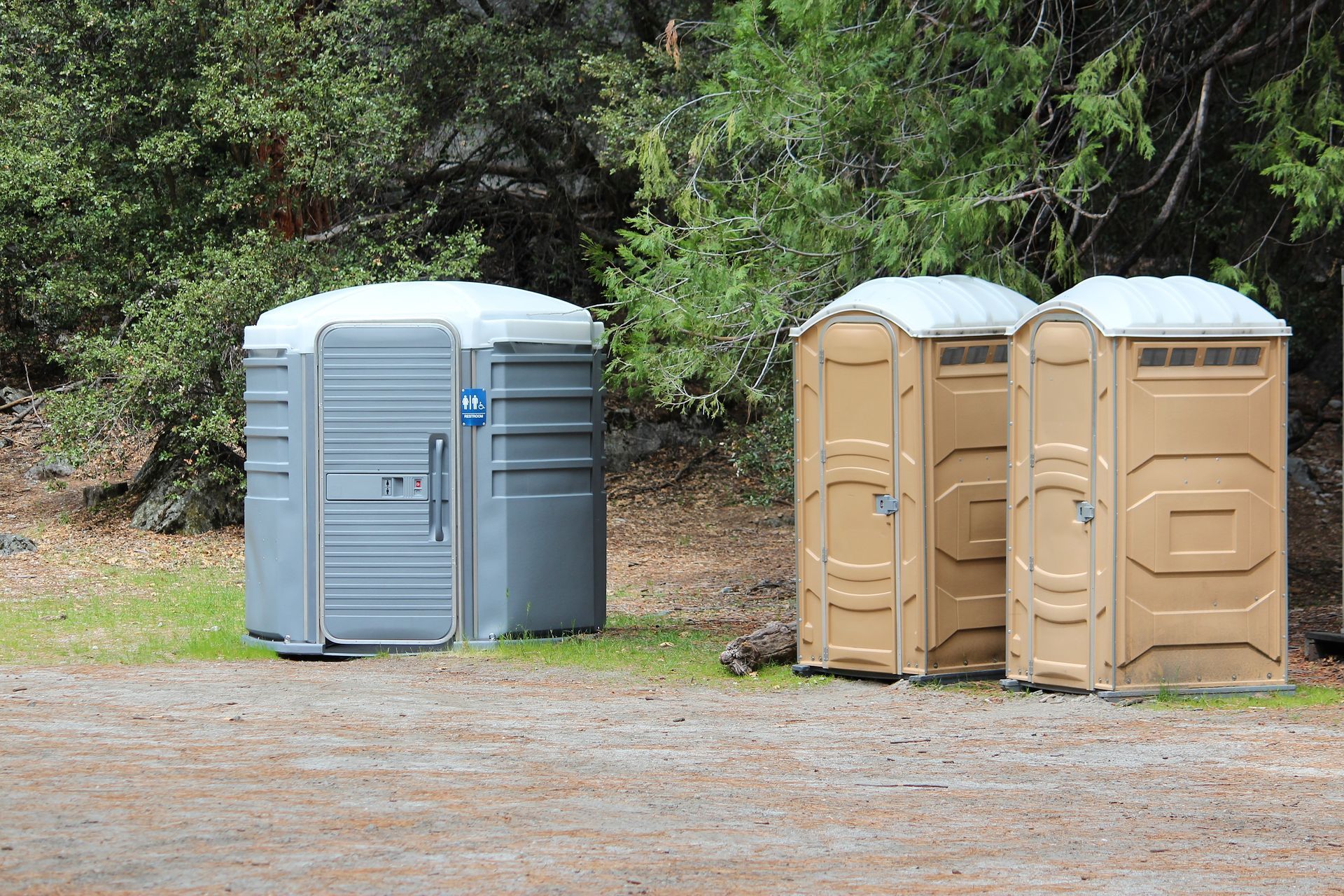 View of clean and accessible portable restroom facilities outdoors.