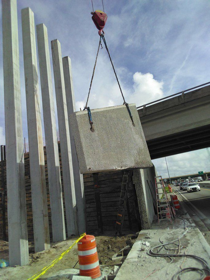 Crane Lifting the Concrete Bar | Kissimmee, FL | Carl's Concrete Cutting & Drilling Inc.