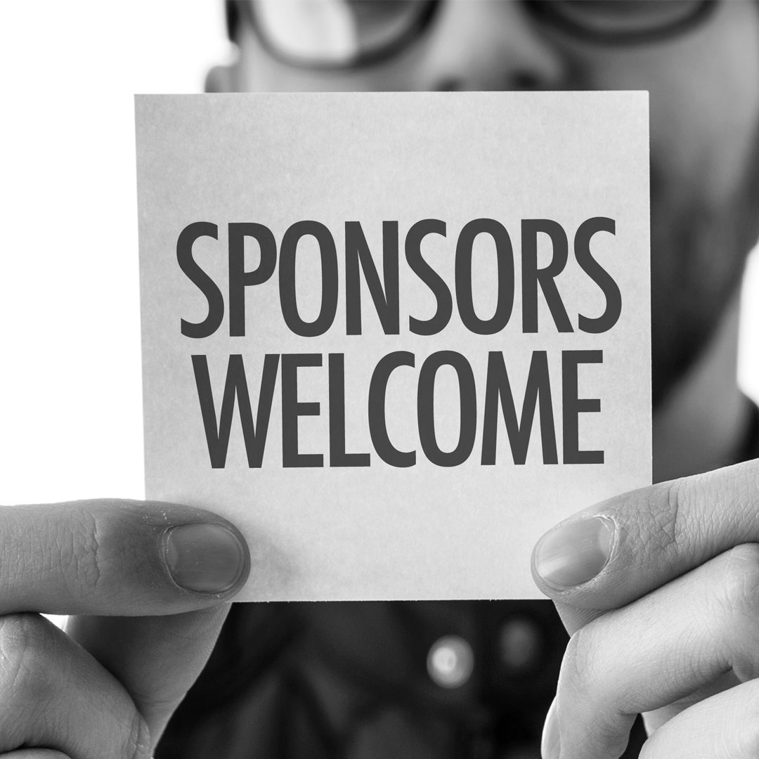 A man is holding a sign that says sponsors welcome