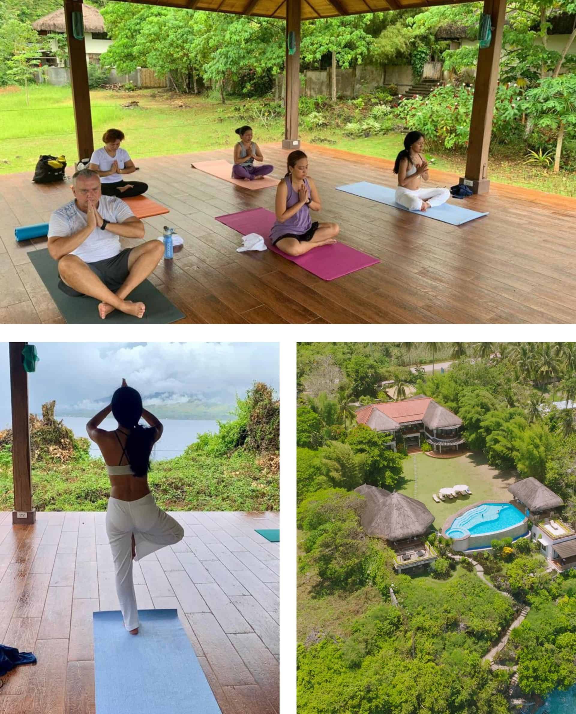 Yoga class in a gazebo, overlooking a body of water.  One person in tree pose. Pool and buildings visible.