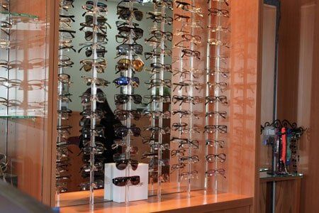 Glasses — Eyeglasses Displayed in the Rack With White Box at Back in Rockingham, NC