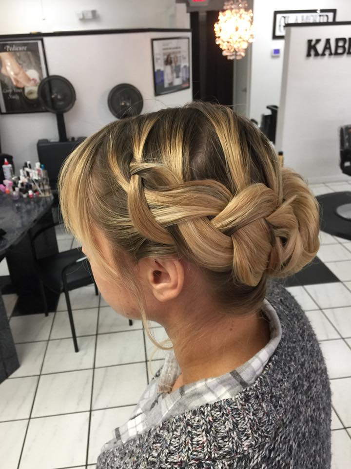 A woman with a braided bun in a salon