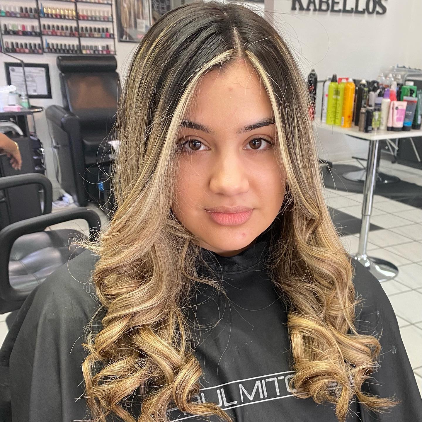 A woman is getting her hair done at a salon.