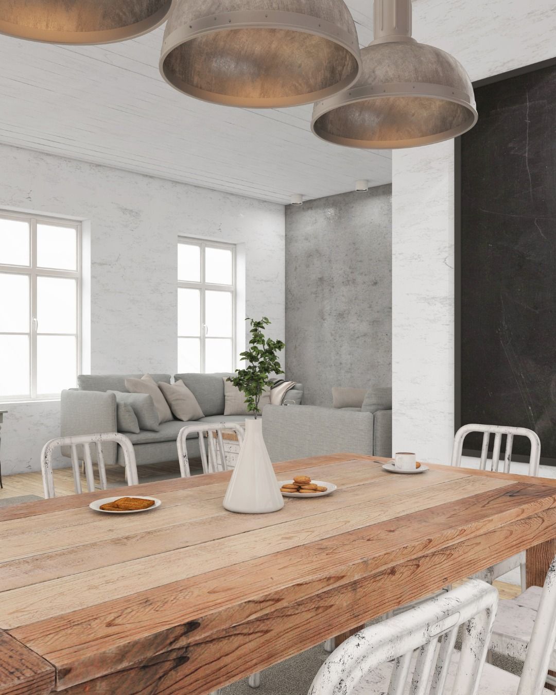 Dining room with wooden table, metal chairs, and industrial light fixtures.