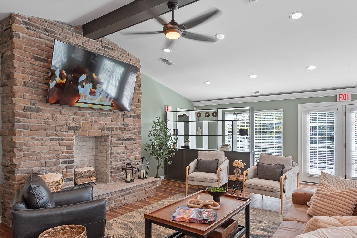 Bridgewater Crossing clubhouse with brick fireplace, mounted TV, and comfortable seating area.