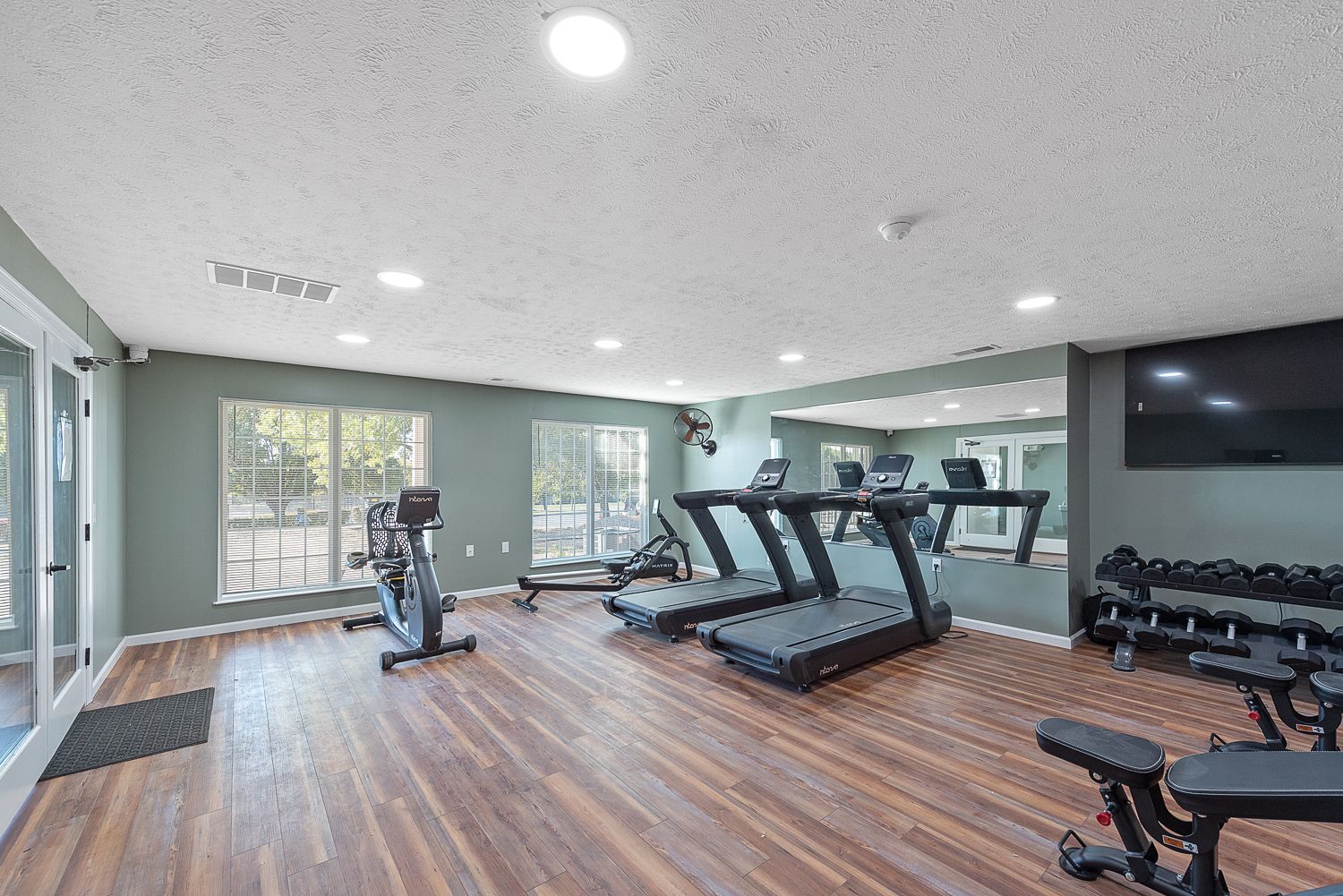 Bridgewater Crossing community fitness center with treadmills, exercise bikes, and flat-screen TV.