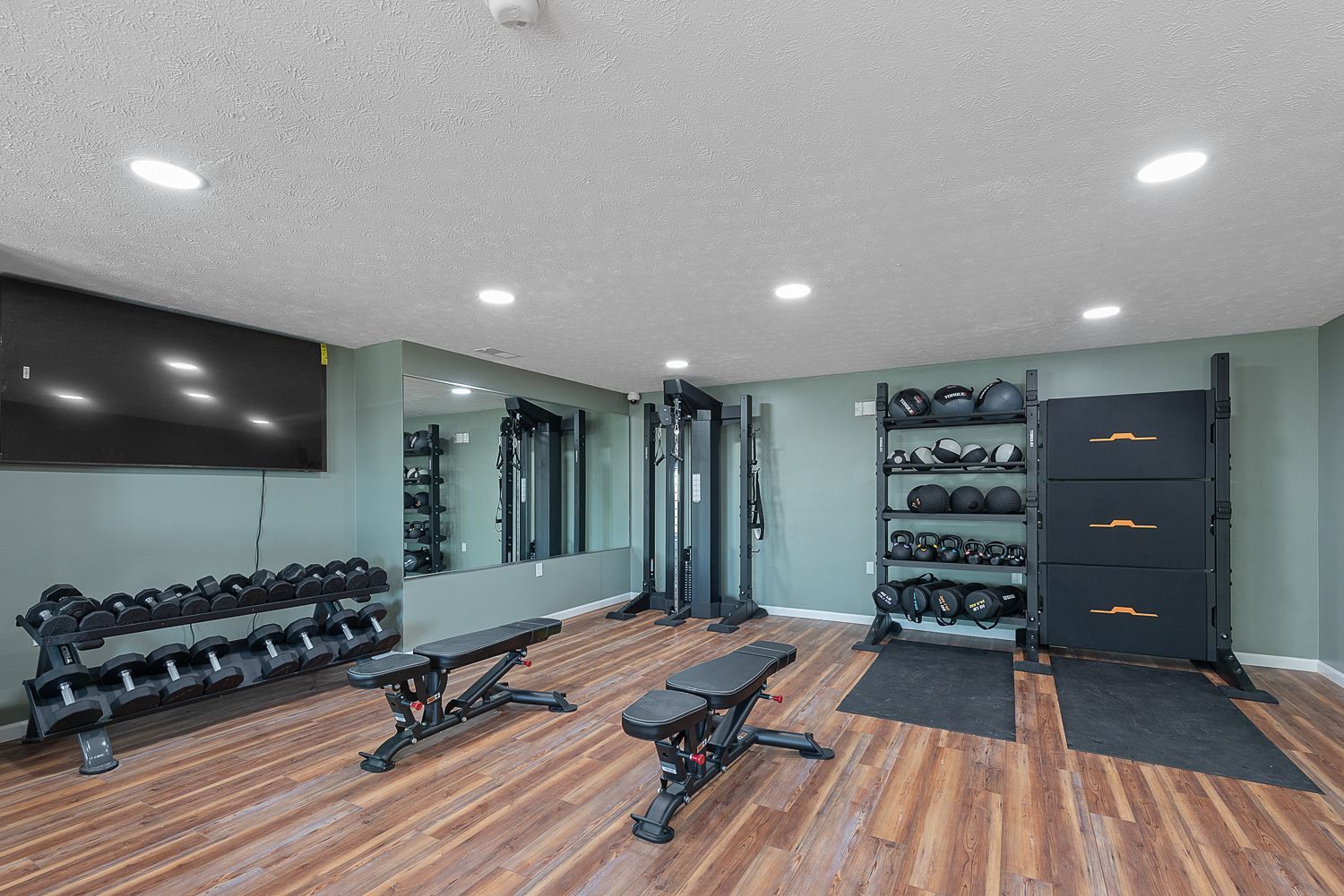 Fitness center at Bridgewater & Knollwood Crossing with free weights, benches and full body system