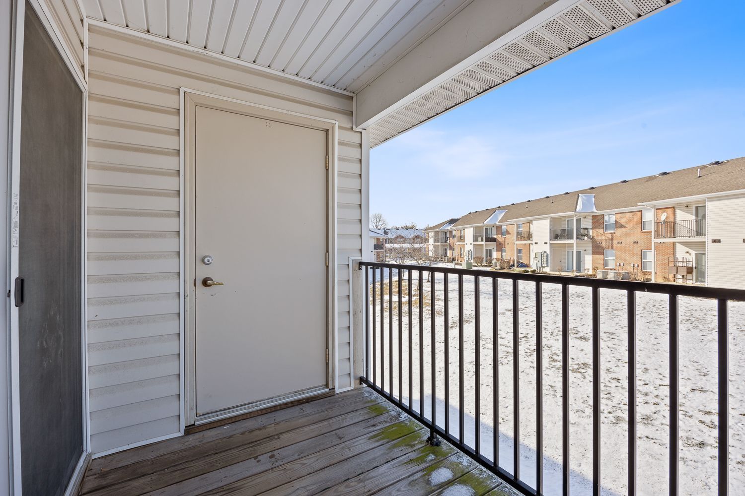 The Elm floor plan private balcony with railing, exterior door, and community view.