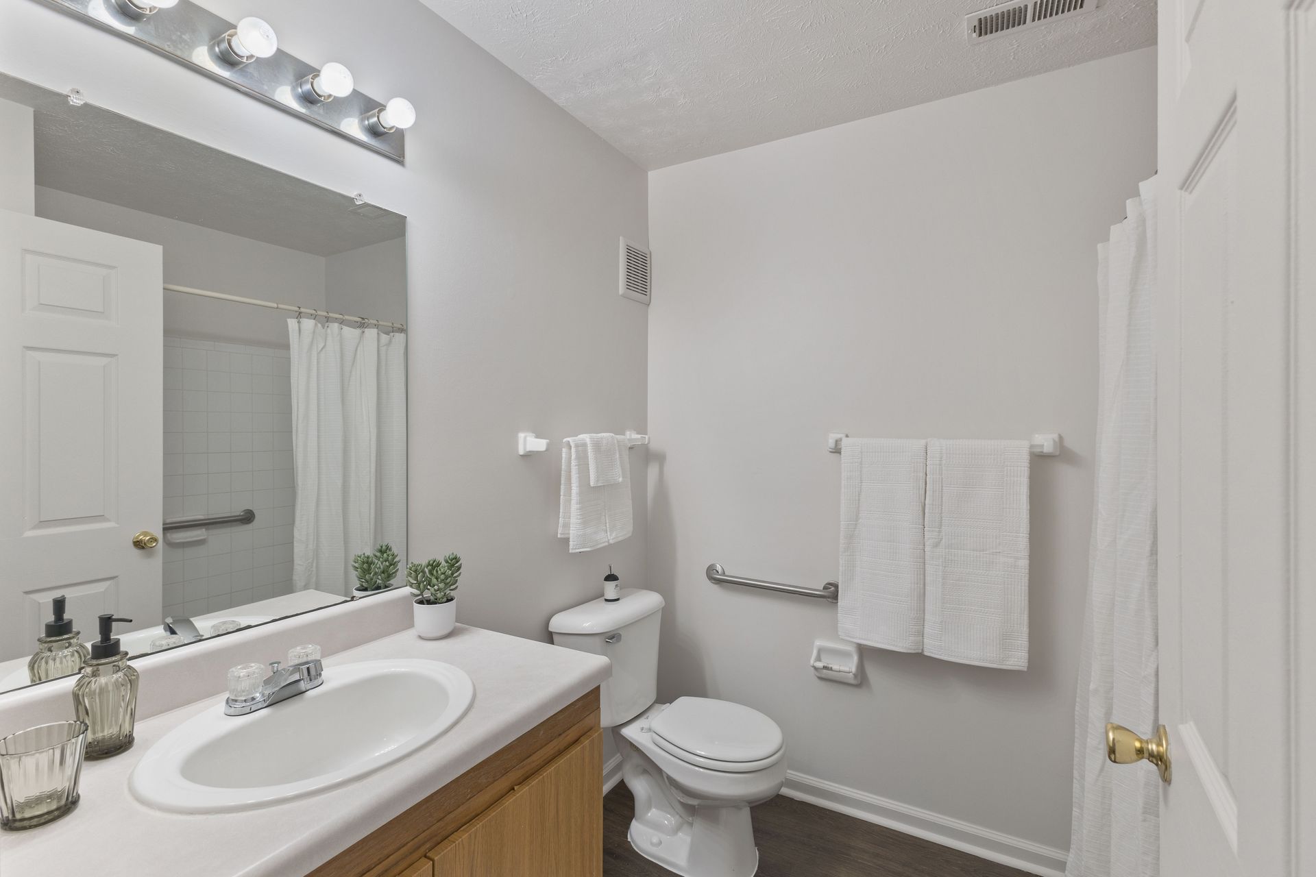 The Maple floor plan bathroom with vanity, mirror, and shower/tub combination.