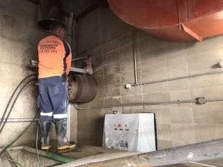 Man Core Drilling Large Hole — Concrete Cutting Services in Bundaberg, QLD