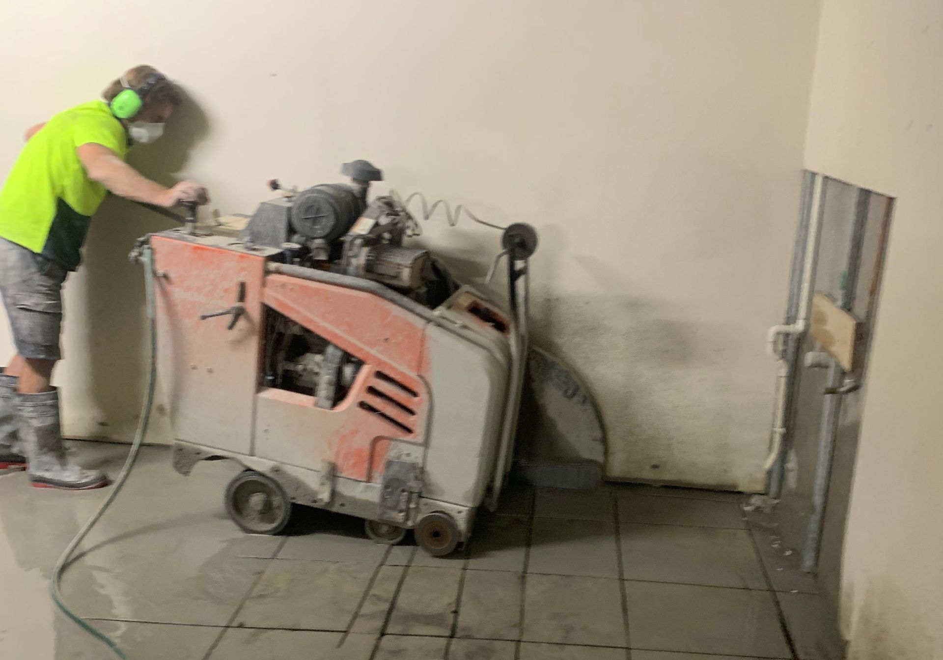 Concrete Cutting Machine Cutting The Floor— Concrete Cutting Services in Bundaberg, QLD