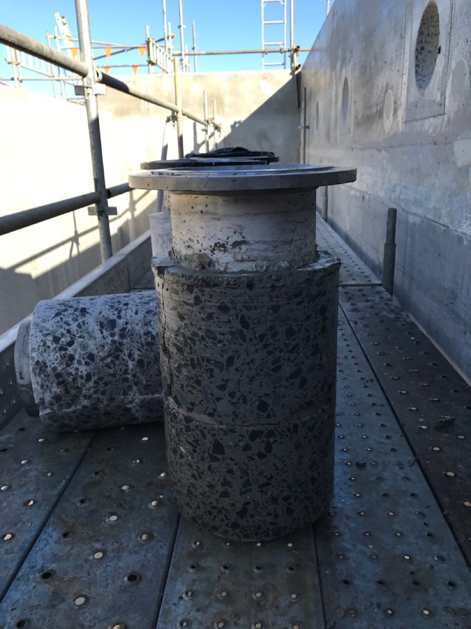 Using Hand Sawing Tool To Cut Concrete From Pipe — Concrete Cutting Services in Bundaberg, QLD