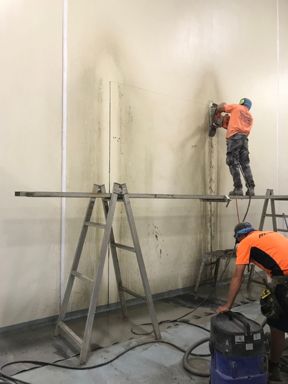 Man Sawing Wall to Create Doorway— Track Wall Sawing in Bundaberg, QLD