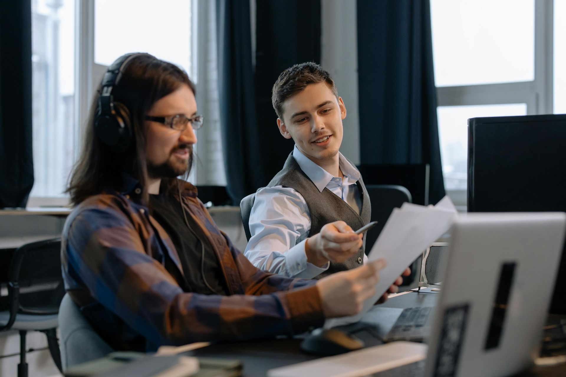 Two office workers looking at documents