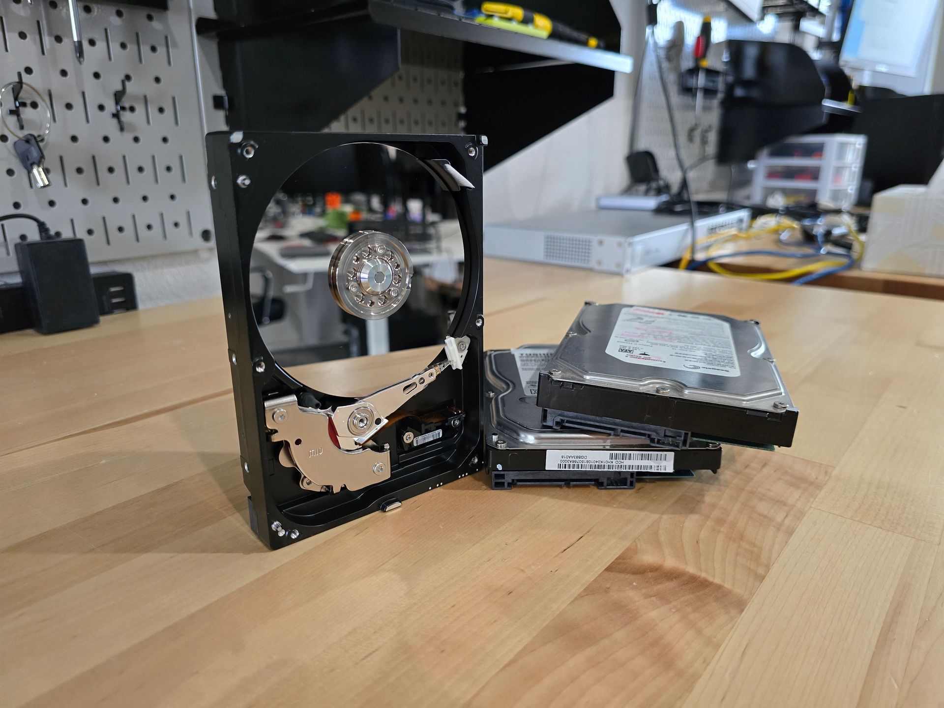 Stack of hard drives on a desk.