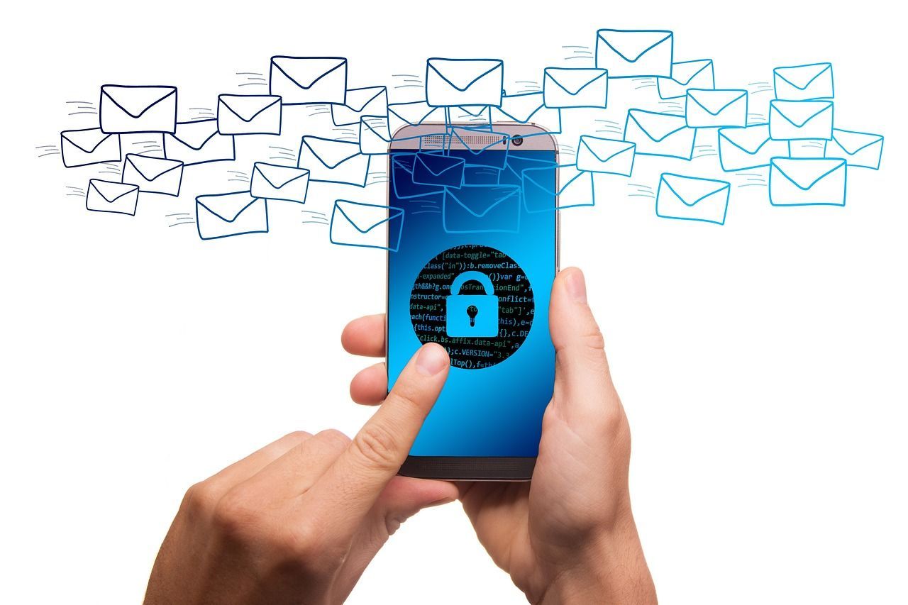 A person is holding a cell phone with a padlock on the screen