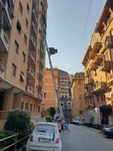 Un'auto bianca è parcheggiata davanti a un alto edificio.